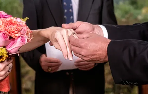placing a ring on her finger